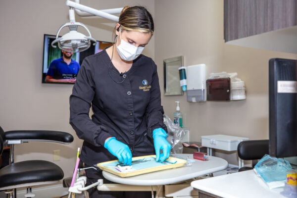 Sand-Lake-Dental-student with tray Sand-Lake-Dental-student with tray